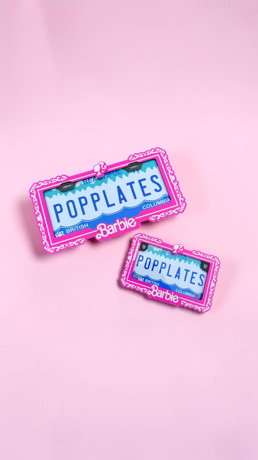 Two Barbie pop plates, one for car, the other for motorcycle, on a pink background