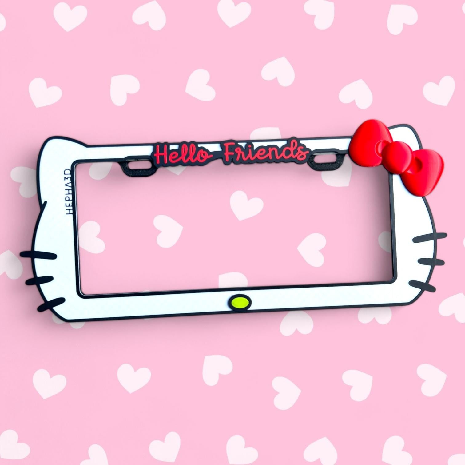 Hello Kitty x PopPlates — 3D printed kawaii license plate frame with bow and cat ear details, available in red and pink, made in Vancouver BC
