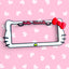 Hello Kitty x PopPlates — 3D printed kawaii license plate frame with bow and cat ear details, available in red and pink, made in Vancouver BC
