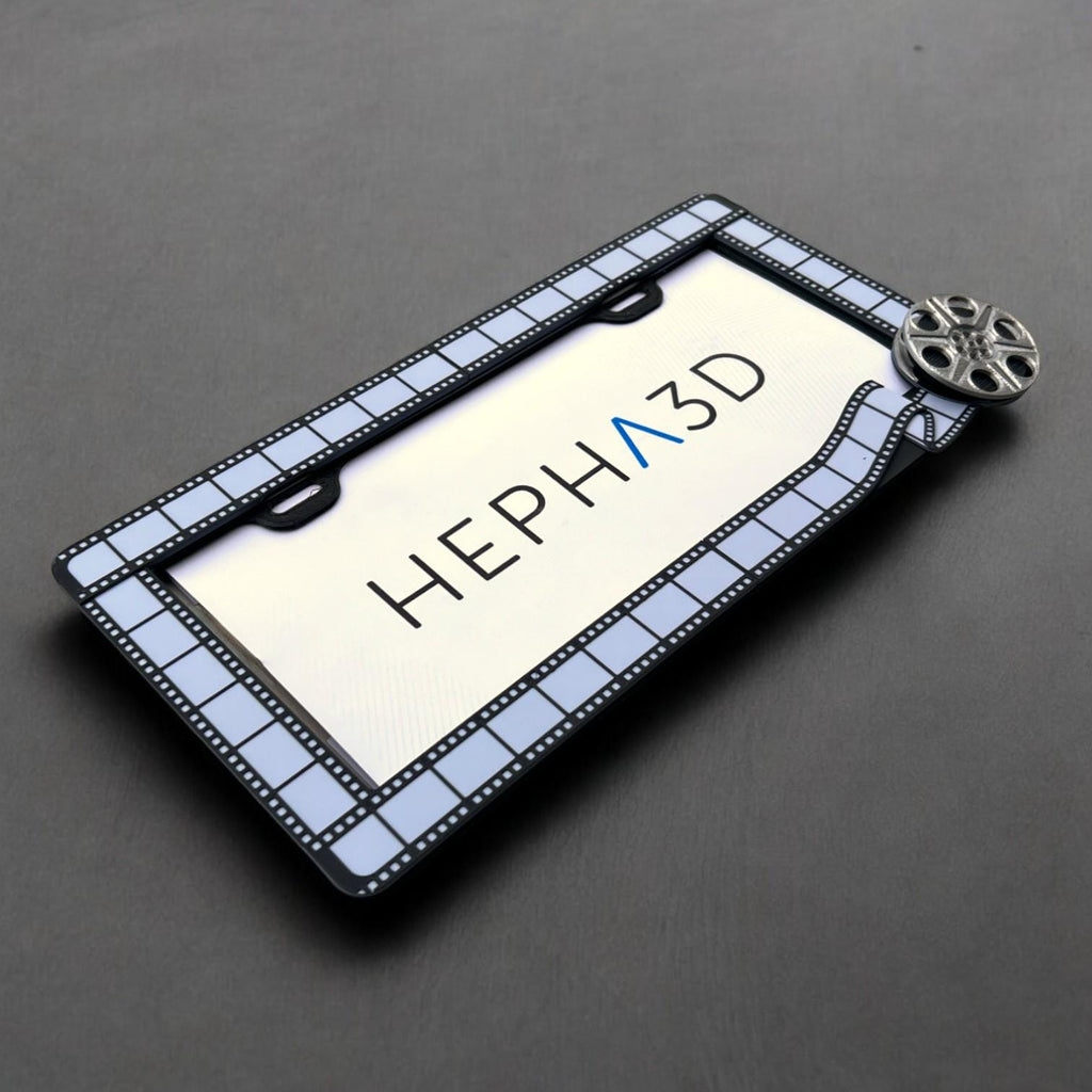 Filmmaker x PopPlates — 3D printed original license plate frame with film strip and clapperboard details, made in Vancouver BC