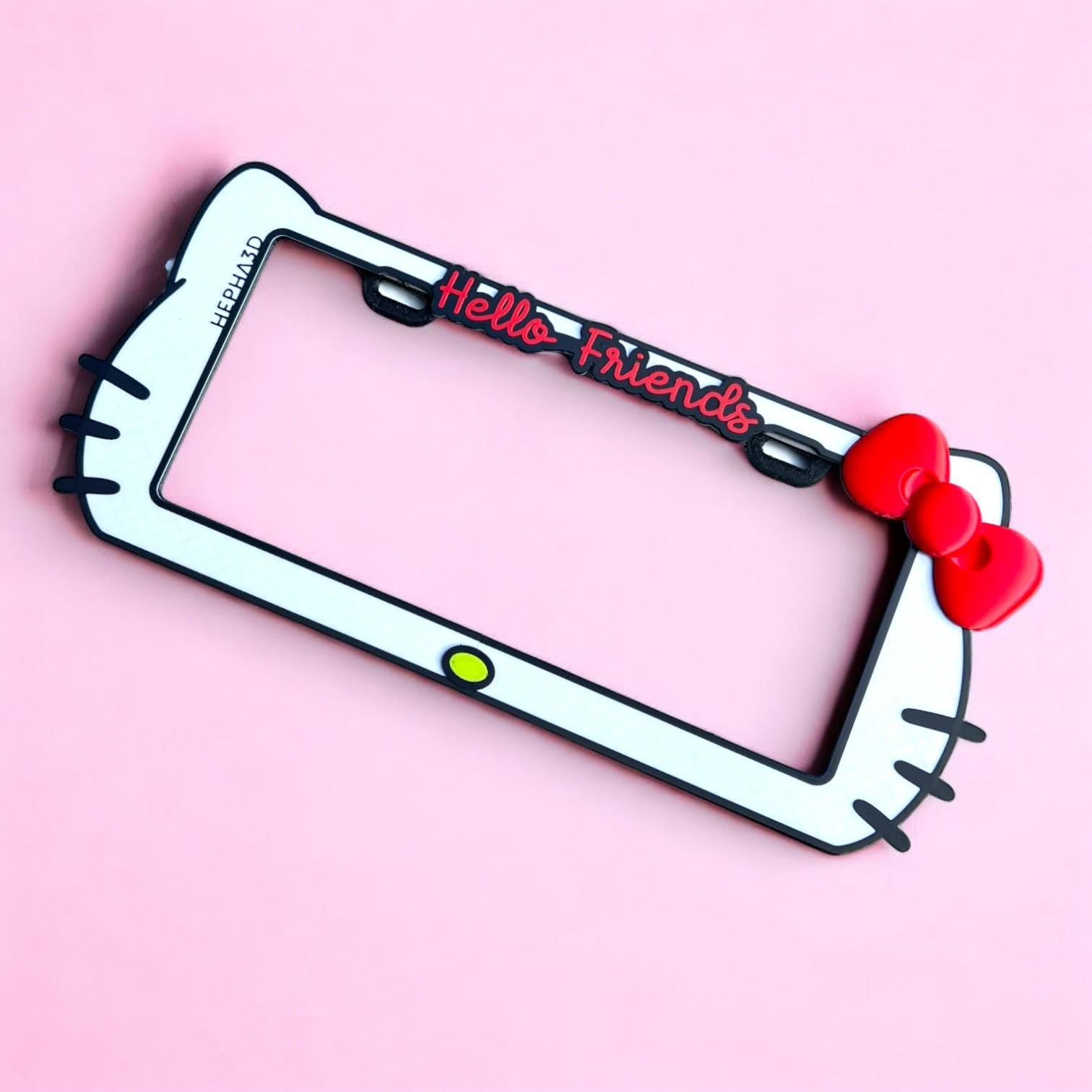 Hello Kitty x PopPlates — 3D printed kawaii license plate frame with bow and cat ear details, available in red and pink, made in Vancouver BC