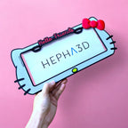 Hello Kitty x PopPlates — 3D printed kawaii license plate frame with bow and cat ear details, available in red and pink, made in Vancouver BC