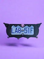 Kuromi x PopPlates — 3D printed gothic-kawaii license plate frame with pointed cat ears and pink skull accent, made in Vancouver BC