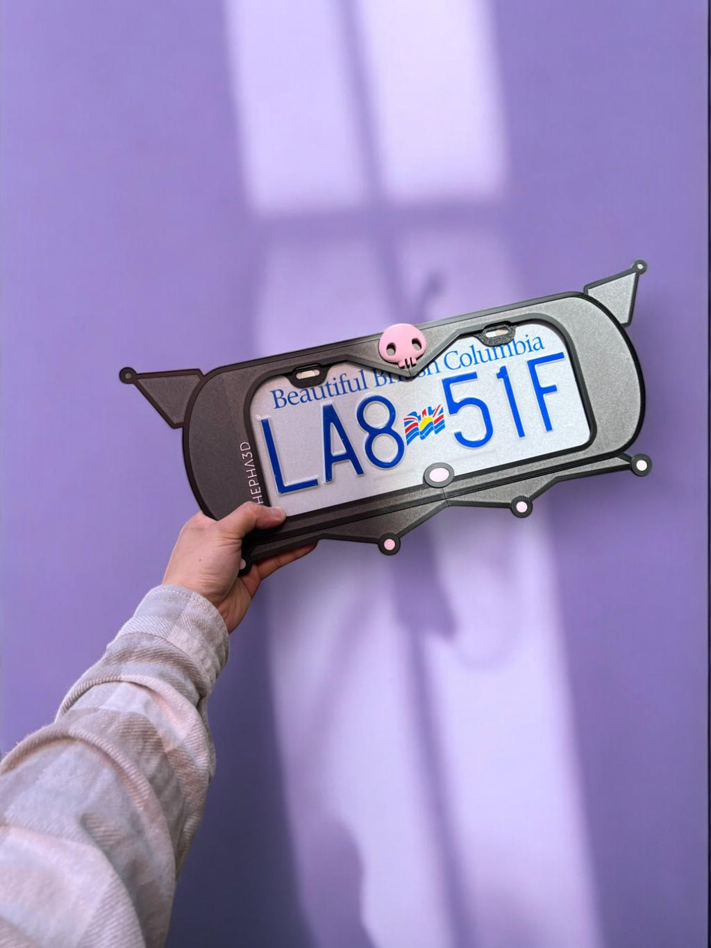 Kuromi x PopPlates — 3D printed gothic-kawaii license plate frame with pointed cat ears and pink skull accent, made in Vancouver BC