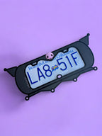 Kuromi x PopPlates — 3D printed gothic-kawaii license plate frame with pointed cat ears and pink skull accent, made in Vancouver BC