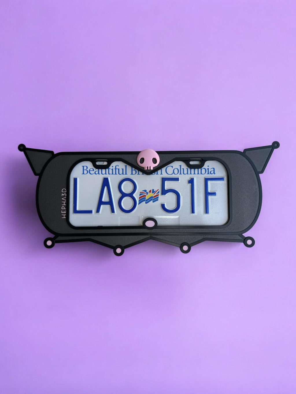 Kuromi x PopPlates — 3D printed gothic-kawaii license plate frame with pointed cat ears and pink skull accent, made in Vancouver BC