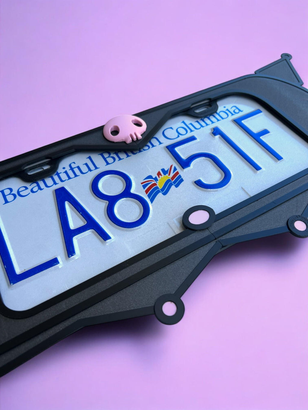 Kuromi x PopPlates — 3D printed gothic-kawaii license plate frame with pointed cat ears and pink skull accent, made in Vancouver BC