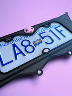 Kuromi x PopPlates — 3D printed gothic-kawaii license plate frame with pointed cat ears and pink skull accent, made in Vancouver BC