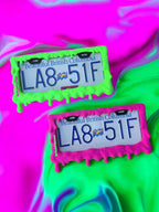 Toxic Goop x PopPlates — 3D printed original license plate frame with dramatic dripping slime effect, available in neon green and magenta, made in Vancouver BC